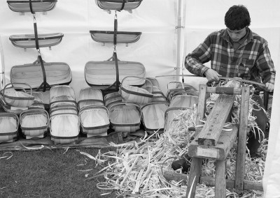 A man making baskets in a craft tent at the Malvern show