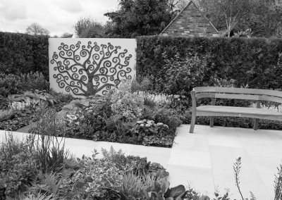A Malvern show garden with curly tree decoration