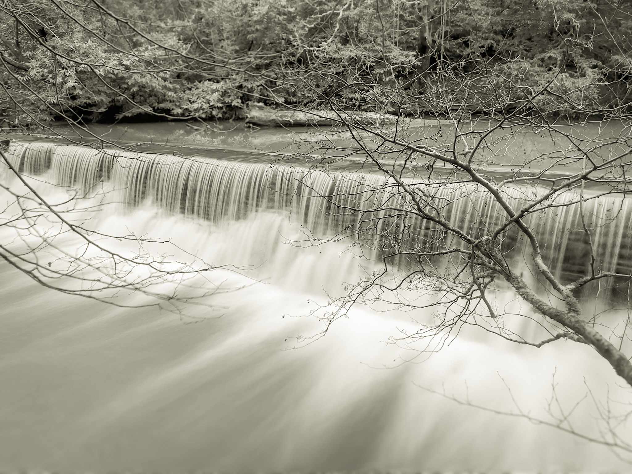 The weir at Snuff Mills photographed in January 2025 This is a long exposure black and white photograph of the weir at Snuff Mills taken in January 2025